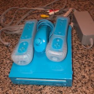 Blue Wii console with 3 controllers
